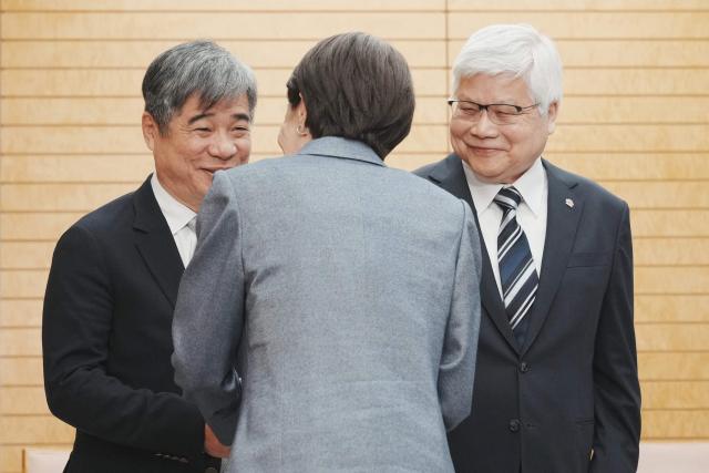 Japan's Prime Minister Sanae Takaichi (C) greets TSMC Chairman CC Wei (R) and Vice President Jonathan Lee (L) at the Prime Minister's Office in Tokyo on February 5, 2026. (Photo by Kazuhiro NOGI / POOL / AFP)