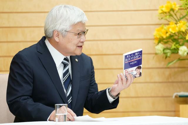 TSMC Chairman CC Wei introduces a book written by Japanese Prime Minister Sanae Takaichi during their meeting at the Prime Minister's Office in Tokyo on February 5, 2026. (Photo by Kazuhiro NOGI / POOL / AFP)