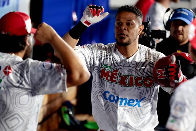 Charros de Jalisco's #17 Reynaldo Rodriguez celebrates with teammates after scoring a run in the second inning of the Caribbean Series baseball tournament eight game between Mexico's Tomateros de Culiacan and Mexico's Charros de Jalisco at the Panamerican Stadium in Jalisco, Mexico, on February 4, 2026. (Photo by Ulises Ruiz / AFP)