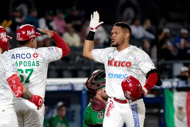 Charros de Jalisco's #17 Reynaldo Rodriguez (R) celebrates with teammates after scoring a run in the second inning of the Caribbean Series baseball tournament eight game between Mexico's Tomateros de Culiacan and Mexico's Charros de Jalisco at the Panamerican Stadium in Jalisco, Mexico, on February 4, 2026. (Photo by Ulises Ruiz / AFP)