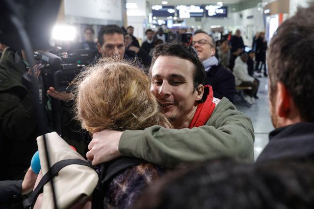 French national Tom Felix is greeted by friends and relatives as he arrives at Roissy-Charles de Gaulle Airport after he was acquitted on eight drug-related charges at the Malaysian High Court, on the outskirts of Paris, on February 5, 2026. A Malaysian court acquitted on February 3 the French national who was facing the death penalty on eight drug-related charges, freeing him after nearly two and a half years in detention. (Photo by GEOFFROY VAN DER HASSELT / AFP)