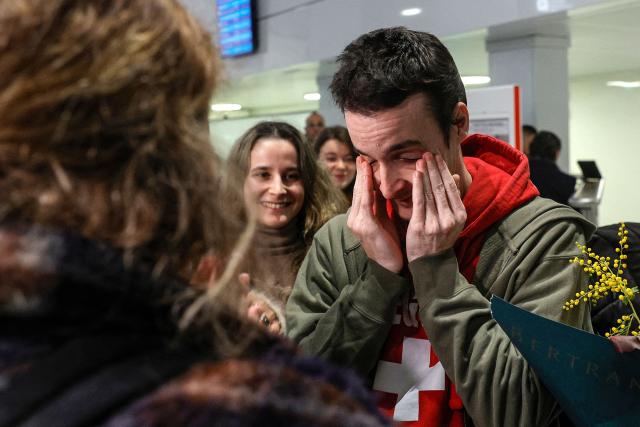 French national Tom Felix is greeted by friends and relatives as he arrives at Roissy-Charles de Gaulle Airport after he was acquitted on eight drug-related charges at the Malaysian High Court, on the outskirts of Paris, on February 5, 2026. A Malaysian court acquitted on February 3 the French national who was facing the death penalty on eight drug-related charges, freeing him after nearly two and a half years in detention. (Photo by GEOFFROY VAN DER HASSELT / AFP)