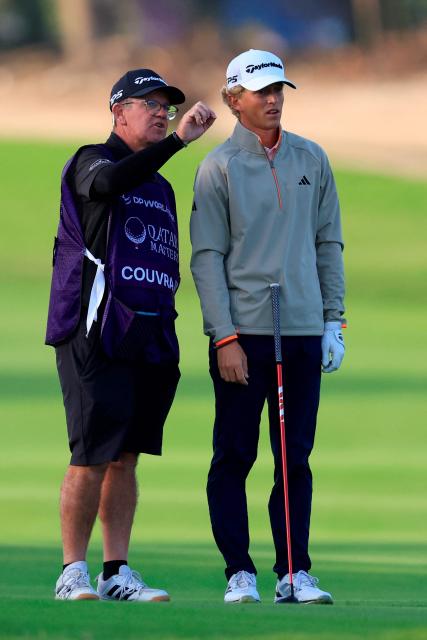 France's Martin Couvra listens to his caddy on day one of the Qatar Masters 2026 at Doha Golf Club, in Doha on February 5, 2026. (Photo by Karim JAAFAR / AFP)