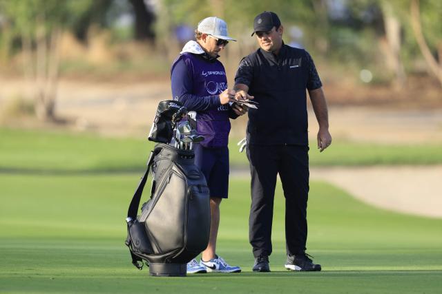 US Patrick Reed speaks with his caddy on day one of the Qatar Masters 2026 at Doha Golf Club, in Doha on February 5, 2026. (Photo by Karim JAAFAR / AFP)