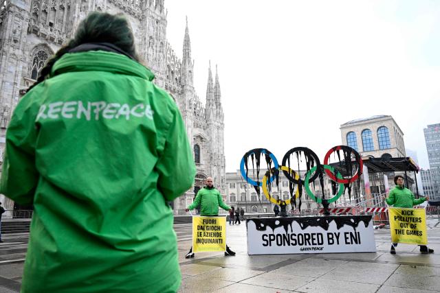 Greenpeace activists stage a protest against Italian oil and gas giant Eni’s sponsorships of the Milano Cortina 2026 Olympic Games at Piazza Duomo in Milan on February 5, 2026. (Photo by WANG Zhao / AFP)