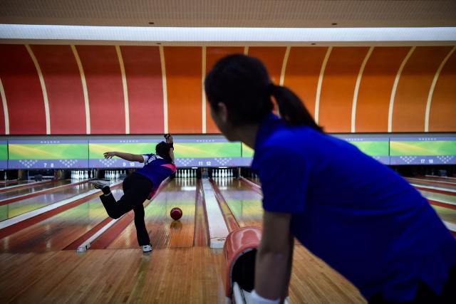 Players take part in a bowling tournament held at the Pyongyang Gold Lane in Pyongyang on February 5, 2026. (Photo by KIM Won Jin / AFP)