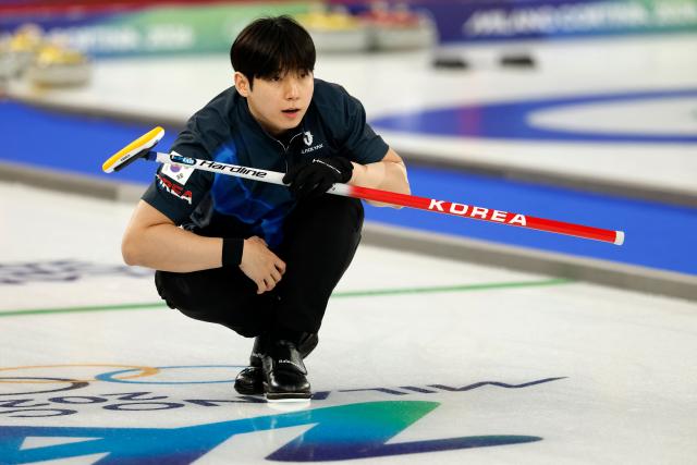 South Korea's Jeong Yeongseok watches after curling the stone in the curling mixed doubles round robin between South Korea and Italy during the Milano Cortina 2026 Winter Olympic Games at the Cortina Curling Olympic Stadium in Cortina d’Ampezzo on February 5, 2026. (Photo by Odd ANDERSEN / AFP)