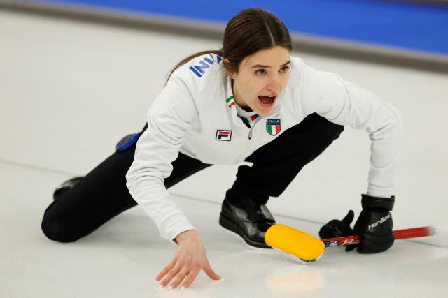 Italy's Stefania Constantini reacts after curling the stone in the curling mixed doubles round robin between South Korea and Italy during the Milano Cortina 2026 Winter Olympic Games at the Cortina Curling Olympic Stadium in Cortina d’Ampezzo on February 5, 2026. (Photo by Odd ANDERSEN / AFP)