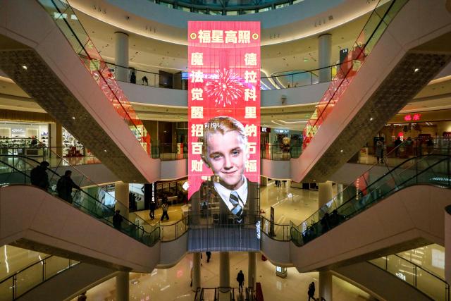 A giant Lunar New Year poster featuring English actor Tom Felton posing as Draco Malfoy, a character from the Harry Potter movies series, is seen at a shopping mall in Shangqiu, in China’s central Henan province on February 5, 2026. The character has become popular in China in the buildup to the Year of the Horse because the transliteration of his surname contains the Chinese characters for "horse" and "good fortune", making him an auspicious omen for the year ahead. (Photo by AFP) / China OUT