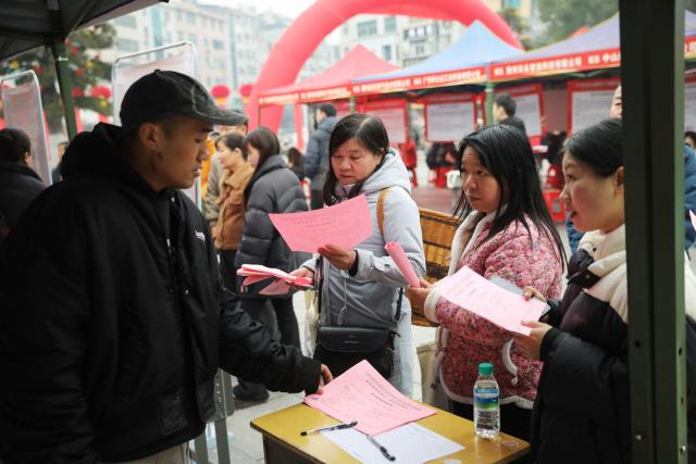 People attend a pre-Lunar New Year job fair in Longshan County, in China’s central Hunan province on February 5, 2026. (Photo by AFP) / China OUT