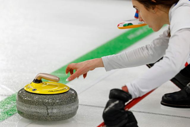 Italy's Stefania Constantini curls the stone in the curling mixed doubles round robin between South Korea and Italy during the Milano Cortina 2026 Winter Olympic Games at the Cortina Curling Olympic Stadium in Cortina d’Ampezzo on February 5, 2026. (Photo by Odd ANDERSEN / AFP)