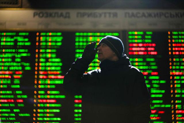 A man looks at a train timetable at the Kiev central train station on February 4, 2026, amid the Russian invasion of Ukraine. (Photo by OLEKSII FILIPPOV / AFP)