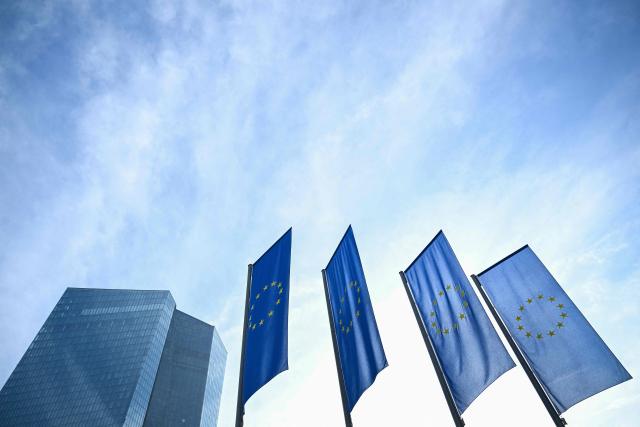 (FILES) European Union flags fly outside the European Central Bank (ECB) headquarters in Frankfurt am Main, western Germany, on December 18, 2025, prior to the meeting on the Eurozone's monetary policy,. A rising euro and falling inflation will present fresh challenges for the European Central Bank at its meeting on February 5, 2026, potentially reviving debate about if and when policymakers should start cutting interest rates. (Photo by Kirill KUDRYAVTSEV / AFP)