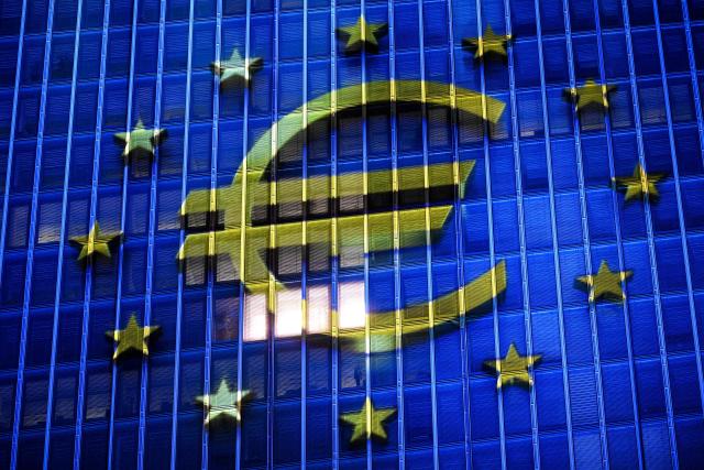 (FILES) A projection of a Euro currency sign is pictured on the facade of the European Central Bank (ECB) headquarters in Frankfurt am Main, western Germany, on December 30, 2025 as a preview of the ECB main building illumination in celebration of Bulgaria’s accession to the euro area. A rising euro and falling inflation will present fresh challenges for the European Central Bank at its meeting on February 5, 2026, potentially reviving debate about if and when policymakers should start cutting interest rates. (Photo by Kirill KUDRYAVTSEV / AFP)