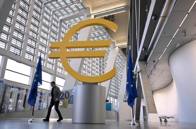 (FILES) A man walks past the logo of the European Central Bank (ECB)   at the central bank's headquarters in Frankfurt am Main, western Germany, on December 18, 2025, prior to the meeting on the Eurozone's monetary policy,. A rising euro and falling inflation will present fresh challenges for the European Central Bank at its meeting on February 5, 2026, potentially reviving debate about if and when policymakers should start cutting interest rates. (Photo by Kirill KUDRYAVTSEV / AFP)