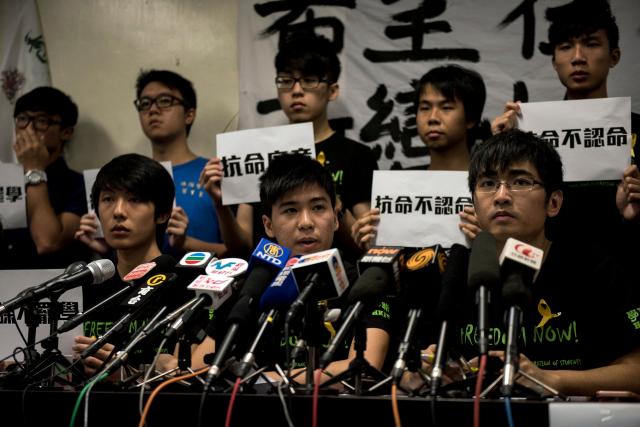(FILES) Lester Shum (C), deputy secretary general of the Hong Kong Federation of Students, speaks at a press conference in Hong Kong on September 7, 2014. A pro-democracy student organisation in Hong Kong said on February 5, 2026 its members had decided to dissolve, citing "increasingly severe pressures". Established in 1958, the Hong Kong Federation of Students (HKFS) played a leading role in mobilising the Chinese city's student community to participate in once-vibrant social movements. (Photo by Alex Ogle / AFP)