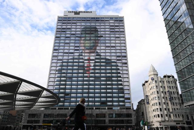 This photograph shows a reproduction of the painting “The Son of Man” by Belgian surrealist painter Rene Magritte on the facade of a hotel in Brussels, on February 4, 2026. (Photo by Nicolas TUCAT / AFP)