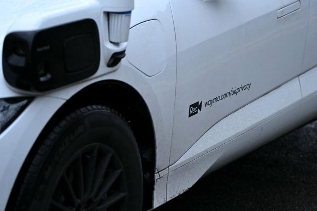 A car from US self-driving car company Waymo is pictured in the streets of central London on February 5, 2026. Waymo said on January 29, 2026 it is working with UK partners to launch driverless robotaxis in London, which are expected to begin operating later this year. The approvals are dependant on when a new law, the Automated Vehicles (AV) Act, is implemented. (Photo by JUSTIN TALLIS / AFP)