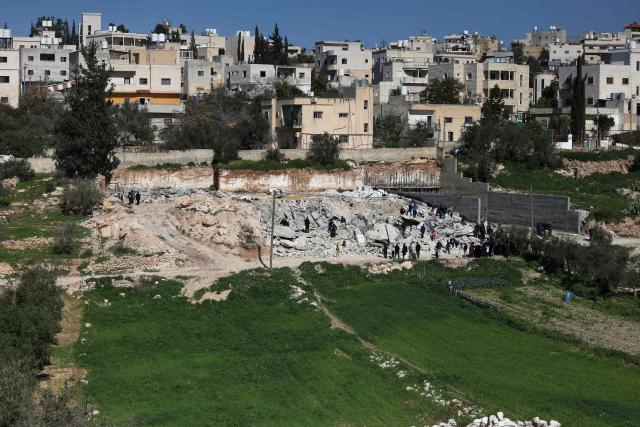 Palestinian homes and shops lie in ruins after bulldozers protected by Israeli security forces demolished the buildings belonging to Palestinian families in Beit Aawa, west the Israeli-occupied West Bank city of Hebron on February 5, 2026. Israel, whose army has occupied the West Bank since 1967, regularly demolishes the homes of Palestinians accused of carrying out deadly attacks against Israelis and of not having construction permits issued by Israel. The government defends the deterrent effect of these demolitions, but critics denounce the practice as a form of collective punishment that leaves families homeless. (Photo by HAZEM BADER / AFP)