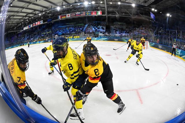 Sweden's defender #08 Hilda Svensson (2nd L) fights for the puck with Germany's defender #08 Ronja Hark (C) during the women's preliminary round Group B Ice Hockey match between Sweden and Germany at the Milano Rho Ice Hockey Arena during the Milano Cortina 2026 Winter Olympic Games, in Milan, on February 5, 2026. (Photo by Alexander NEMENOV / AFP)