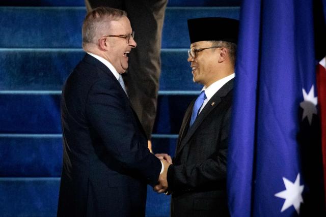 Australia's Prime Minister Anthony Albanese (L) is welcomed by Indonesia’s Foreign Minister Sugiono upon his arrival at the Halim Perdanakusuma International Airport in Jakarta on February 5, 2026. (Photo by Yasuyoshi CHIBA / AFP)