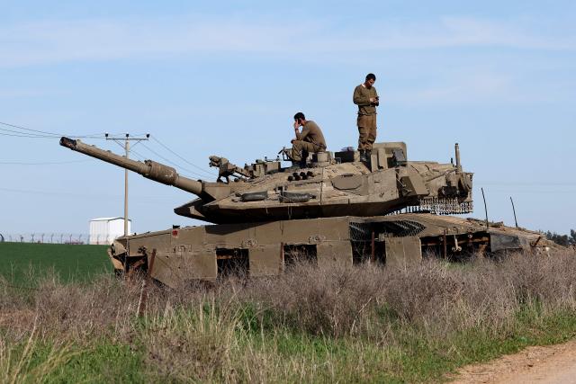 This picture taken from a position at Israel's border with the Gaza Strip shows Israeli troops deployed near the border fence with the besieged Palestinian territory on February 5, 2026. The October 7, 2023, Hamas attack just across the Israel-Gaza Strip border which resulted in the deaths of 1,221 people on the Israeli side, triggered the Gaza war in which over 71,800 Palestinians have been killed and thousands of buildings destroyed. (Photo by Jack GUEZ / AFP)