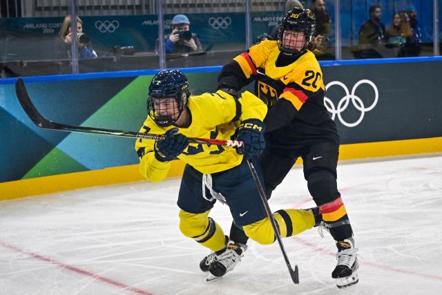 Sweden's defender #07 Mira Jungaker (L) is body checked by Germany's defender #20 Daria Gleissner during the women's preliminary round Group B Ice Hockey match between Sweden and Germany at the Milano Rho Ice Hockey Arena during the Milano Cortina 2026 Winter Olympic Games, in Milan, on February 5, 2026. (Photo by Alexander NEMENOV / AFP)