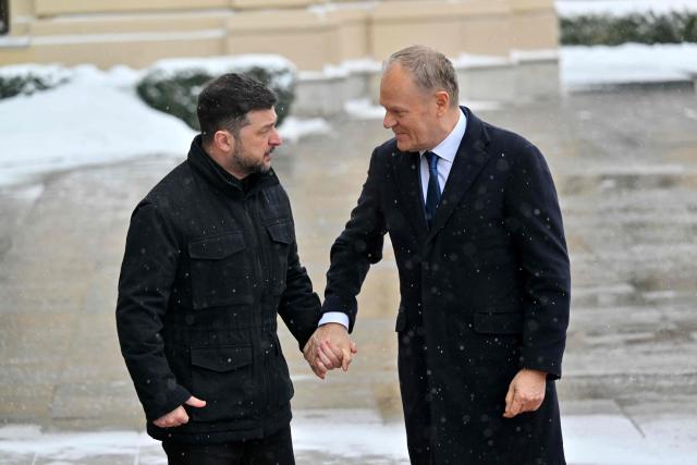 Ukrainian President Volodymyr Zelensky (L) welcomes Poland's Prime Minister Donald Tusk (R) ahead of their meeting at the Mariinskyi Palace in Kyiv, on February 5, 2026. (Photo by Sergei SUPINSKY / AFP)