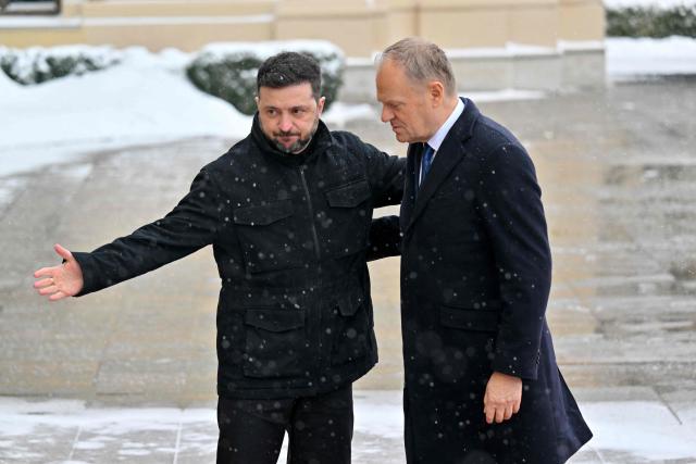 Ukrainian President Volodymyr Zelensky (L) welcomes Poland's Prime Minister Donald Tusk (R) ahead of their meeting at the Mariinskyi Palace in Kyiv, on February 5, 2026. (Photo by Sergei SUPINSKY / AFP)