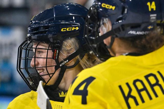 Sweden's defender #08 Hilda Svensson celebrates with teammates at the end of the women's preliminary round Group B Ice Hockey match between Sweden and Germany at the Milano Rho Ice Hockey Arena during the Milano Cortina 2026 Winter Olympic Games, in Milan, on February 5, 2026. Sweden wins 4 - 1 against Germany. (Photo by Alexander NEMENOV / AFP)