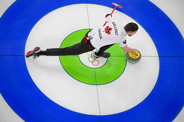 Canada's Brett Gallant curls the stone in the curling mixed doubles round robin between Norway and Canada during the Milano Cortina 2026 Winter Olympic Games at the Cortina Curling Olympic Stadium in Cortina d’Ampezzo on February 5, 2026. (Photo by Odd ANDERSEN / AFP)