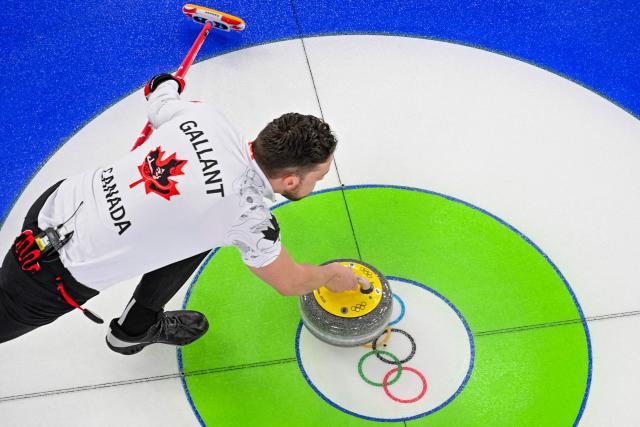 Canada's Brett Gallant curls the stone in the curling mixed doubles round robin between Norway and Canada during the Milano Cortina 2026 Winter Olympic Games at the Cortina Curling Olympic Stadium in Cortina d’Ampezzo on February 5, 2026. (Photo by Odd ANDERSEN / AFP)