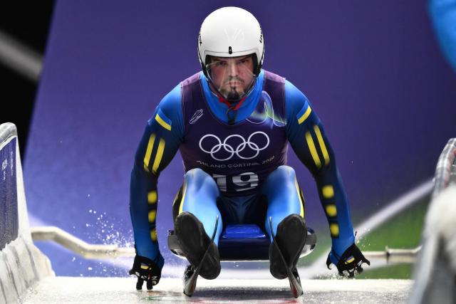 Ukraine's Anton Dukach takes part in the luge men's singles training session at Cortina Sliding Centre during the Milano Cortina 2026 Winter Olympic Games in Cortina d'Ampezzo on February 5, 2026. (Photo by Marco BERTORELLO / AFP)