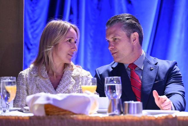 US Secretary of Defense Pete Hegseth (R) speaks with his wife Jennifer Rauchet before US President Trump speaks during the National Prayer Breakfast at the Washington Hilton in Washington, DC on February 5, 2026. (Photo by SAUL LOEB / AFP)