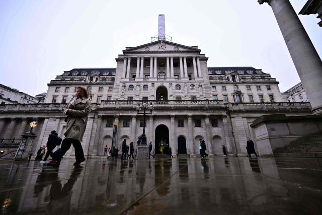 Pedestrians walk past the Bank of England in central London on February 5, 2026. The Bank of England on February 5 cut its forecasts for UK growth this year and next, as it left its benchmark interest rate at 3.75 percent. (Photo by Ben STANSALL / AFP)