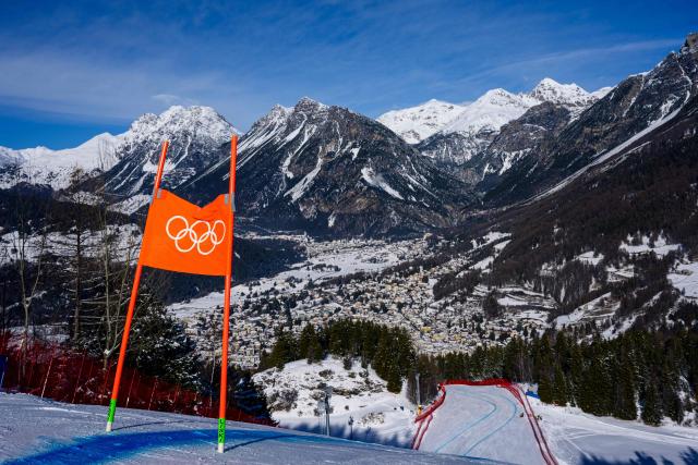This photograph taken on February 5, 2026, shows the Olympic rings on a downhill flag and the Stelvio Alpine Skiing Centre, hosting to the men's Alpine skiing events of the Milano Cortina 2026 Winter Olympic Games in Bormio (Valtellina) on February 5, 2026. (Photo by DIMITAR DILKOFF / AFP)