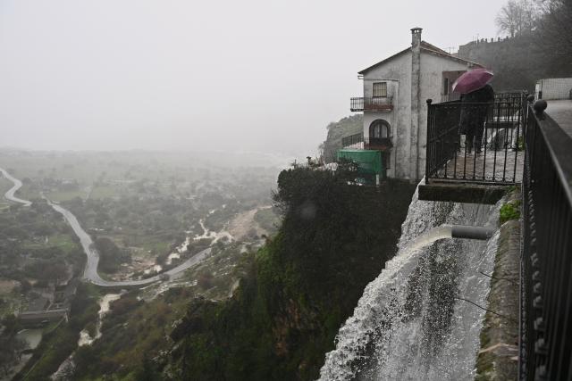 Floodwater flows through Grazalema, southern Spain, on February 5, 2026, amid Storm Leonardo. Spain today lifted its highest weather alert for torrential rain in the southern region of Andalusia, where a woman went missing, a day after the storm killed one in Portugal. Storm Leonardo dumped more than 40 centimetres (15 inches) of rain in some Andalusian districts yesterday, forcing the evacuation of thousands, paralysing rail and road transport and shutting schools. The downpours, which came after a storm killed five people and left hundreds injured in neighbouring Portugal last week, are examples of extreme weather that scientists say climate change is worsening. (Photo by Jorge GUERRERO / AFP)
