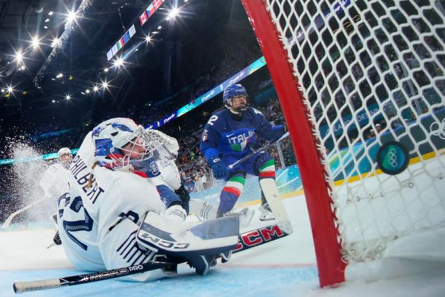 Italy's forward #12 Rebecca Roccella scores a goal past France's goalkeeper #32 Alice Philbert during the women's preliminary round group B Ice Hockey match between Italy and France at the Milano Santagiulia Ice Hockey Arena during the Milano Cortina 2026 Winter Olympic Games in Milan, on February 5, 2026. (Photo by POOL / AFP)