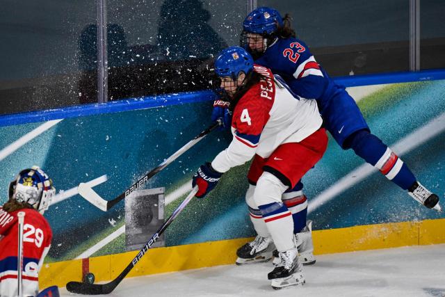 US' forward #23 Hannah Bilka (R) collides with Czech Republic's defender #04 Daniela Pejsova (2nd R) during the women's preliminary round Group A Ice Hockey match between USA and Czech Republic at the Milano Rho Ice Hockey Arena during the Milano Cortina 2026 Winter Olympic Games in Milan, on February 5, 2026. (Photo by Alexander NEMENOV / AFP)