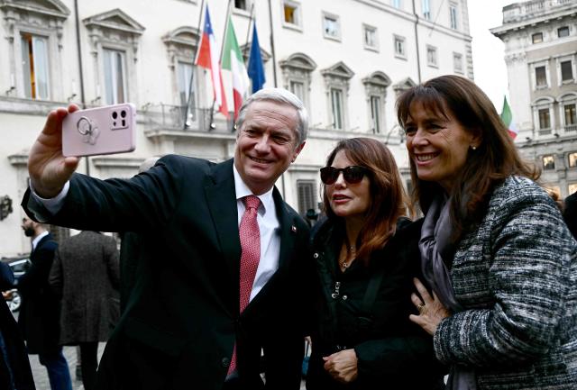 Chile's President-elect Jose Antonio Kast (L) and his wife, Chilean lawyer and activist Maria Pia Adriasola (R), pose for a selfie with a woman after meeting with the Italian Prime Minister at Palazzo Chigi, in Rome on Febuary 5, 2026. (Photo by Filippo MONTEFORTE / AFP)