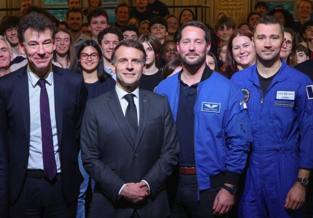 France's President Emmanuel Macron (C) poses with France's Higher Education and Research Minister Philippe Baptiste (L) and ESA (European Space Agency) French astronaut Thomas Pesquet (2nd-R) and French astronaut Arnaud Prost (R) following a video conference with French astronaut Sophie Adenot ahead of her departure for the International Space Station, at the presidential Elysee Palace in Paris on February 5, 2026. Four astronauts could blast off to the International Space Station (ISS) next week, after setbacks including a mysterious medical evacuation of the previous crew, last-minute rocket problems, and some scheduling conflicts with NASA's Moon mission. (Photo by Ludovic MARIN / POOL / AFP)