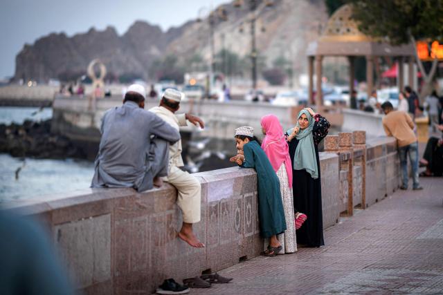 Women stand along the corniche in Oman's capital Muscat on February 5, 2026. (Photo by Loic VENANCE / AFP)
