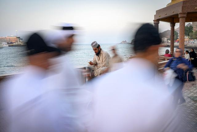 A man sits along the corniche in Oman's capital Muscat on February 5, 2026. (Photo by Loic VENANCE / AFP)