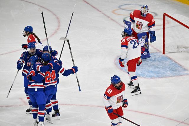 US' #24 Joy Dunne celebrates with teammates after scoring her team's second goal during the women's preliminary round Group A Ice Hockey match between USA and Czech Republic at the Milano Rho Ice Hockey Arena during the Milano Cortina 2026 Winter Olympic Games in Milan, on February 5, 2026. (Photo by Alexander NEMENOV / AFP)