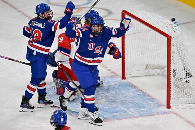 US' #24 Joy Dunne celebrates with teammates after scoring her team's second goal during the women's preliminary round Group A Ice Hockey match between USA and Czech Republic at the Milano Rho Ice Hockey Arena during the Milano Cortina 2026 Winter Olympic Games in Milan, on February 5, 2026. (Photo by Alexander NEMENOV / AFP)
