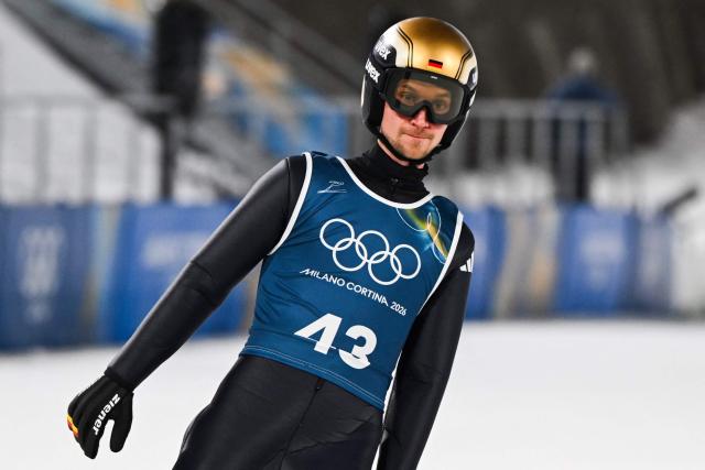 Germany's Felix Hoffmann reacts as he arrives in the finish area after jumping during the men's ski jumping normal hill training of the Milano Cortina 2026 Winter Olympic Games at Predazzo Ski Jumping Stadium in Predazzo (Val di Fiemme), on February 5, 2026. (Photo by Javier SORIANO / AFP)