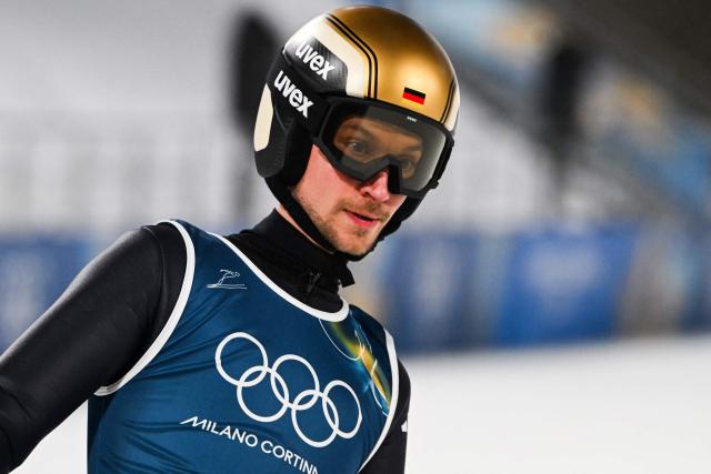 Germany's Felix Hoffmann reacts as he arrives in the finish area after jumping during the men's ski jumping normal hill training of the Milano Cortina 2026 Winter Olympic Games at Predazzo Ski Jumping Stadium in Predazzo (Val di Fiemme), on February 5, 2026. (Photo by Javier SORIANO / AFP)