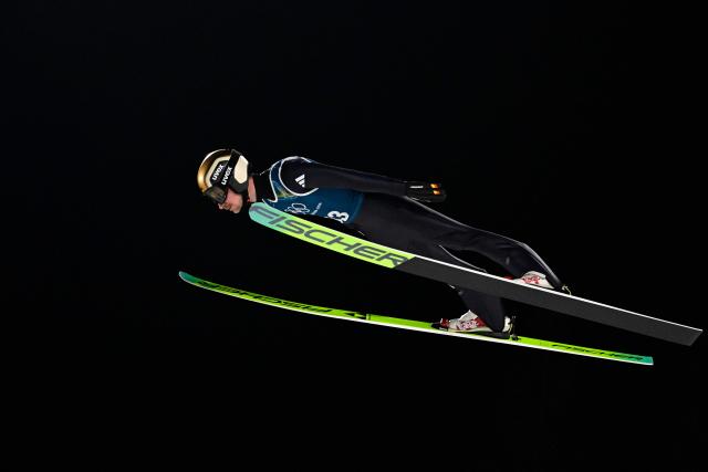 Germany's Felix Hoffmann jumps during the men's ski jumping normal hill training of the Milano Cortina 2026 Winter Olympic Games at Predazzo Ski Jumping Stadium in Predazzo (Val di Fiemme), on February 5, 2026. (Photo by Tobias SCHWARZ / AFP)