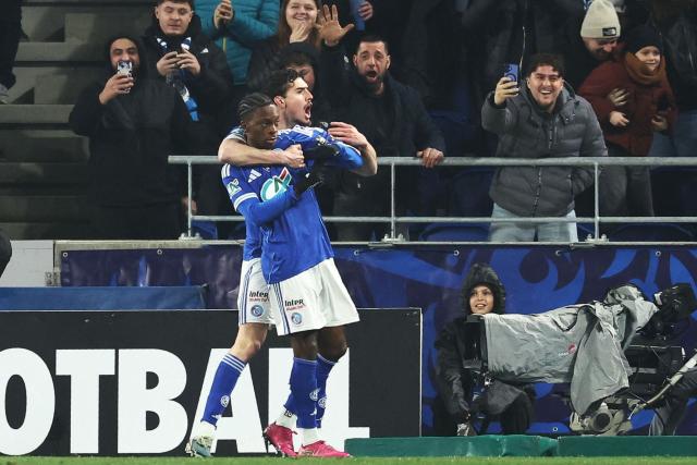 Strasbourg's Ivoirian-British forward #11 Martial Gogo (front) celebrates scoring his team's first goal during the French Cup round of 16 football match between RC Strasbourg Alsace and AS Monaco at the Stade de la Meinau in Strasbourg, eastern France, on February 5, 2026. (Photo by Frederick FLORIN / AFP)