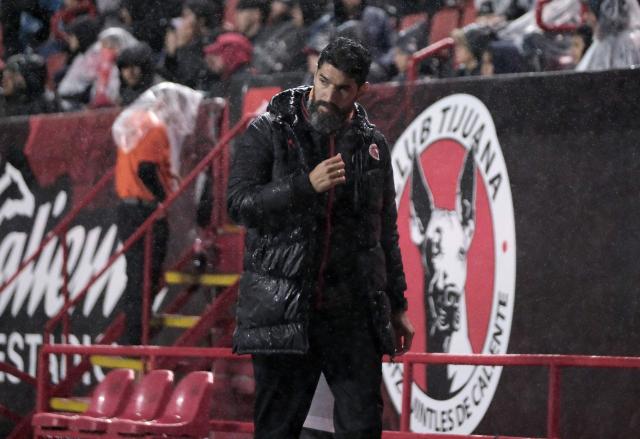 (FILES) Tijuana's Uruguayan head coach Sebastian Abreu gestures during the play-in of Liga MX Apertura football match between Tijuana and Juarez at Caliente Stadium in Tijuana, Mexico on November 20, 2025. It’s only a matter of time before Uruguayan Sebastian “El Loco” Abreu, head coach of Tijuana, stars another of his trademark moments in the Mexican football. This time, he will coach his son Diego in an eagerly anticipated debut that has sparked curiosity in the 2026 Clausura. (Photo by Guillermo Arias / AFP)